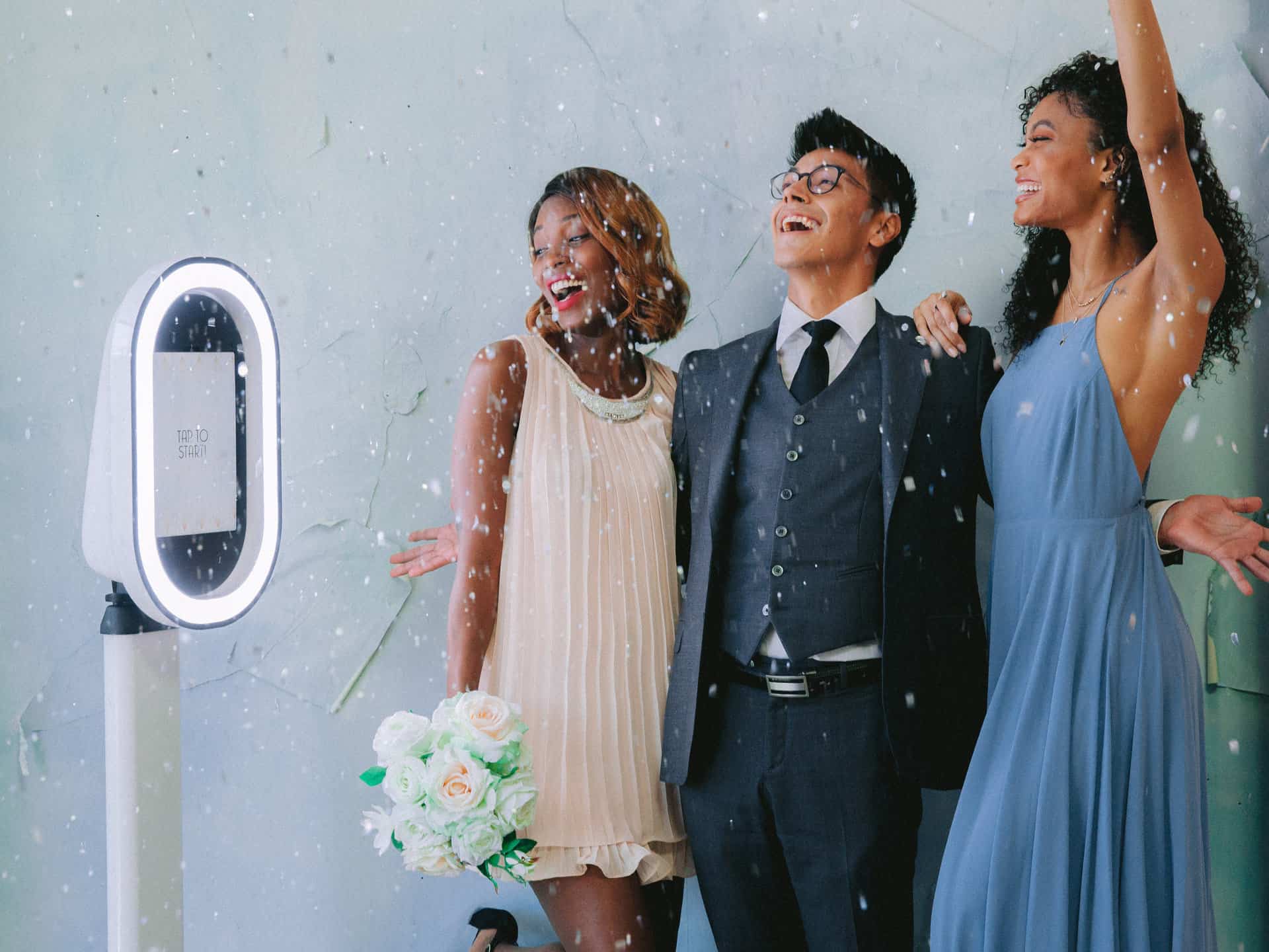 Wedding guests enjoying a Hidden Lens photo booth